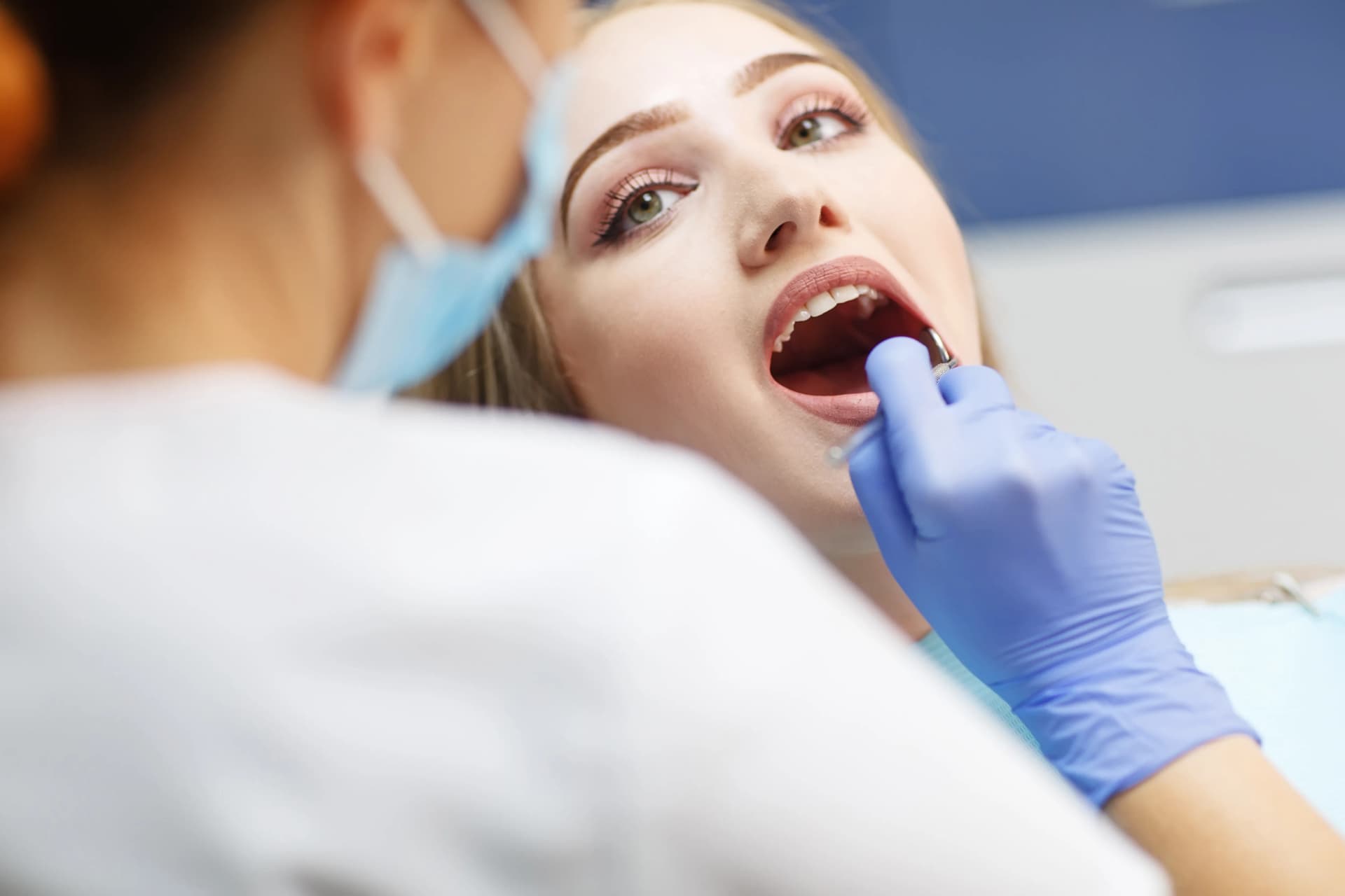 Dentist gently examining a patient during a routine checkup