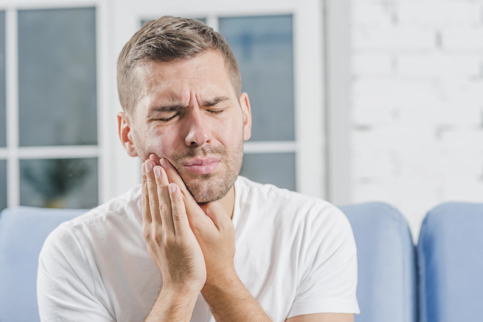 Man holding his jaw with a painful toothache
